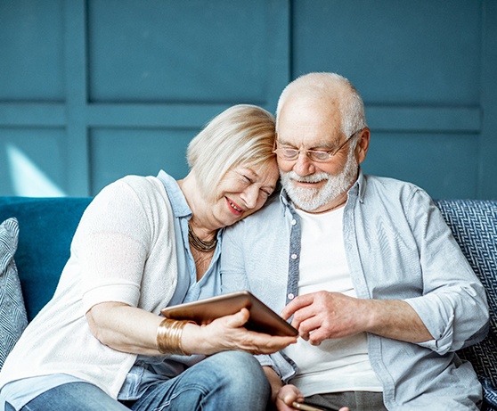 Senior man and woman looking at tablet