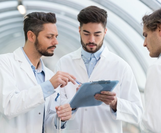 Team of oral surgeons reviewing patient chart