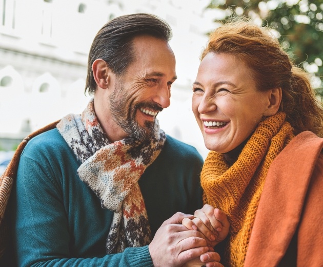 Man and woman smiling after bone grafting