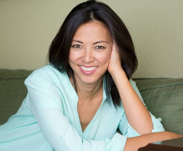 Woman smiling after bone grafting treatment