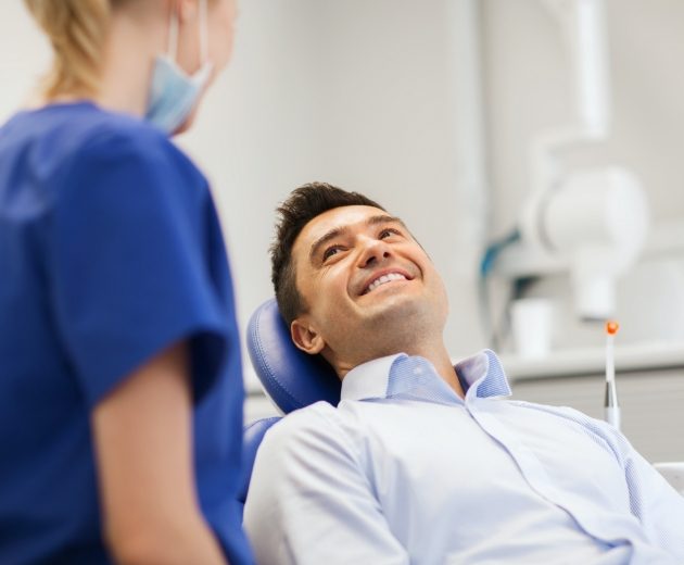 Man smiling at oral surgeon during consultation