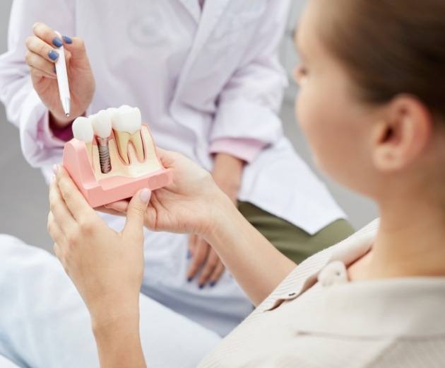 Oral surgeon and patient discussing reasons for tooth extractions