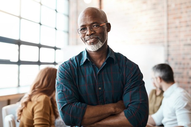 smiling person with their arms crossed