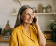 smiling person talking on their phone