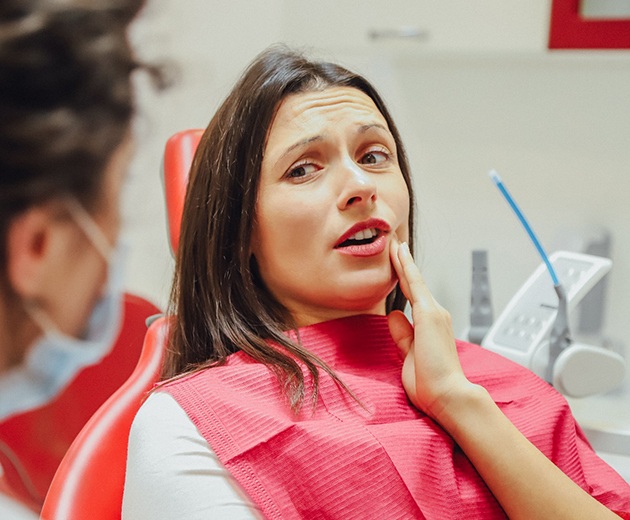 Woman with toothache in dental chair