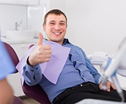 Candidate for IV dental sedation in Alexandria giving thumbs-up