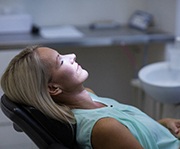 Woman relaxing with oral conscious sedation in Alexandria