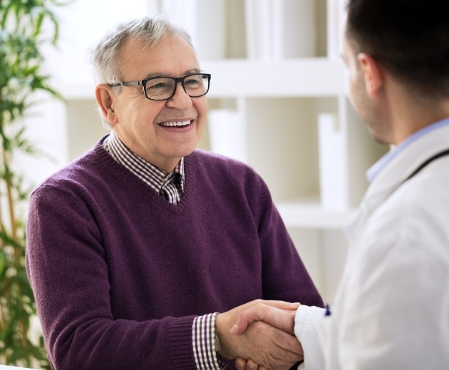 Oral surgeon talking to patient about detecting oral problems