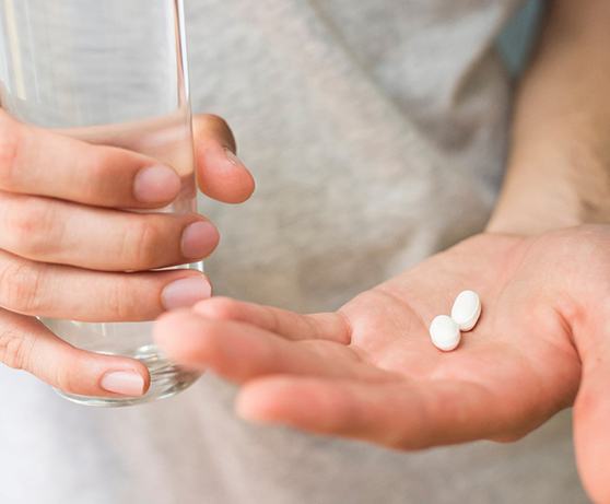 Person holding medication from sedation dentist in Alexandria