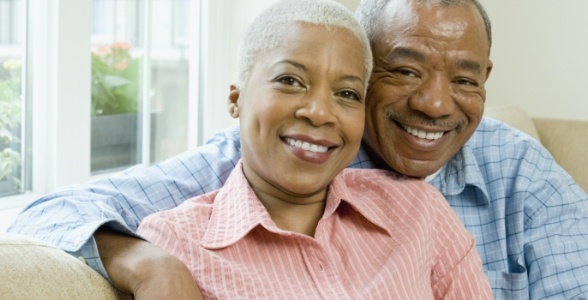 Man and woman smiling after tooth replacement with dental implants