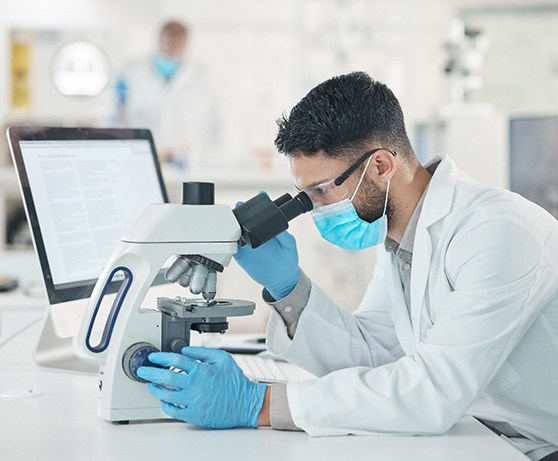 a person looking in a microscope