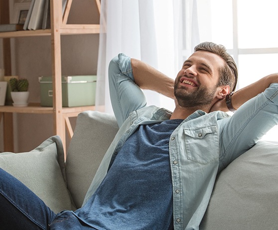 Man resting at home on sofa