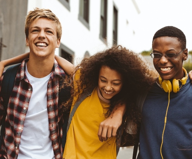 Group of young adults smiling after wisdom tooth extraction