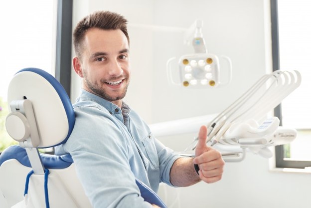 Man at the dentist before getting his wisdom teeth removed during the summertime.