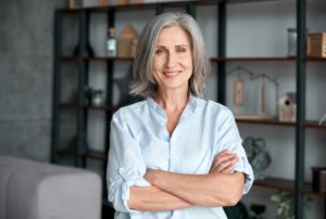 confident woman smiling with her arms folded