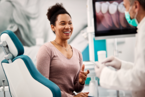 a patient smiling during their dental implant consultation 