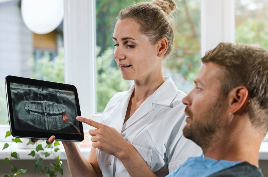 Dentist showing patient wisdom teeth x-ray