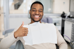 Oral surgery patient giving a thumbs up